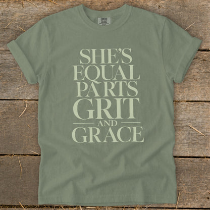 Sage green t-shirt with "She's Equal Parts Grit and Grace" graphic text.