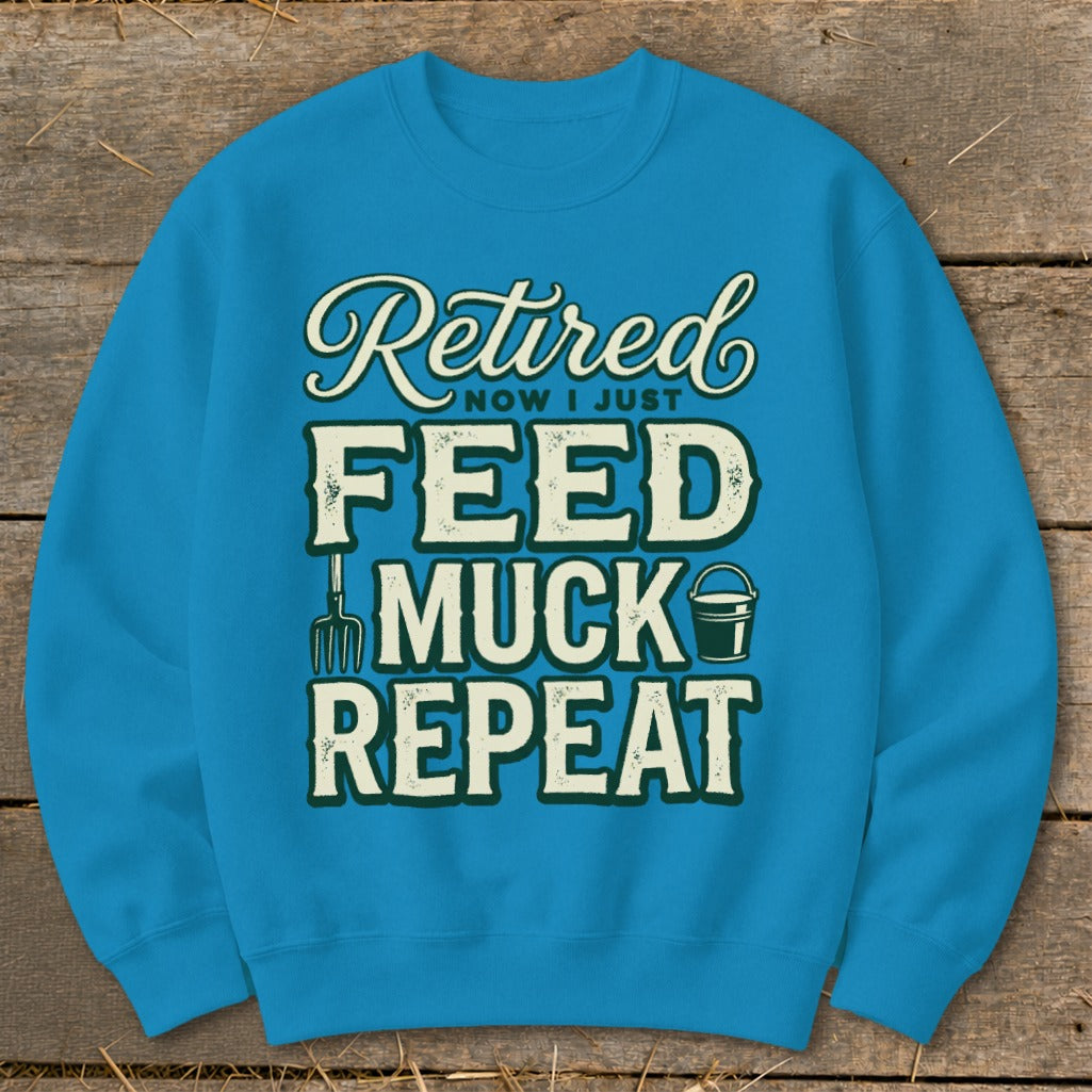 Blue sweatshirt with "Retired Now I Just Feed Muck Repeat" text and graphics.