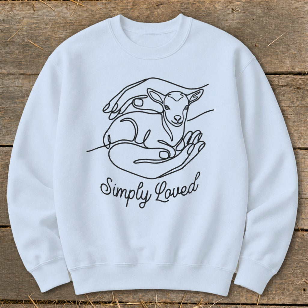 Light blue crewneck sweatshirt with line art of a lamb in hands and "Simply Loved" text.