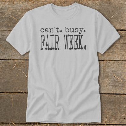 Light gray t-shirt with black text reading "can't. busy. FAIR WEEK."