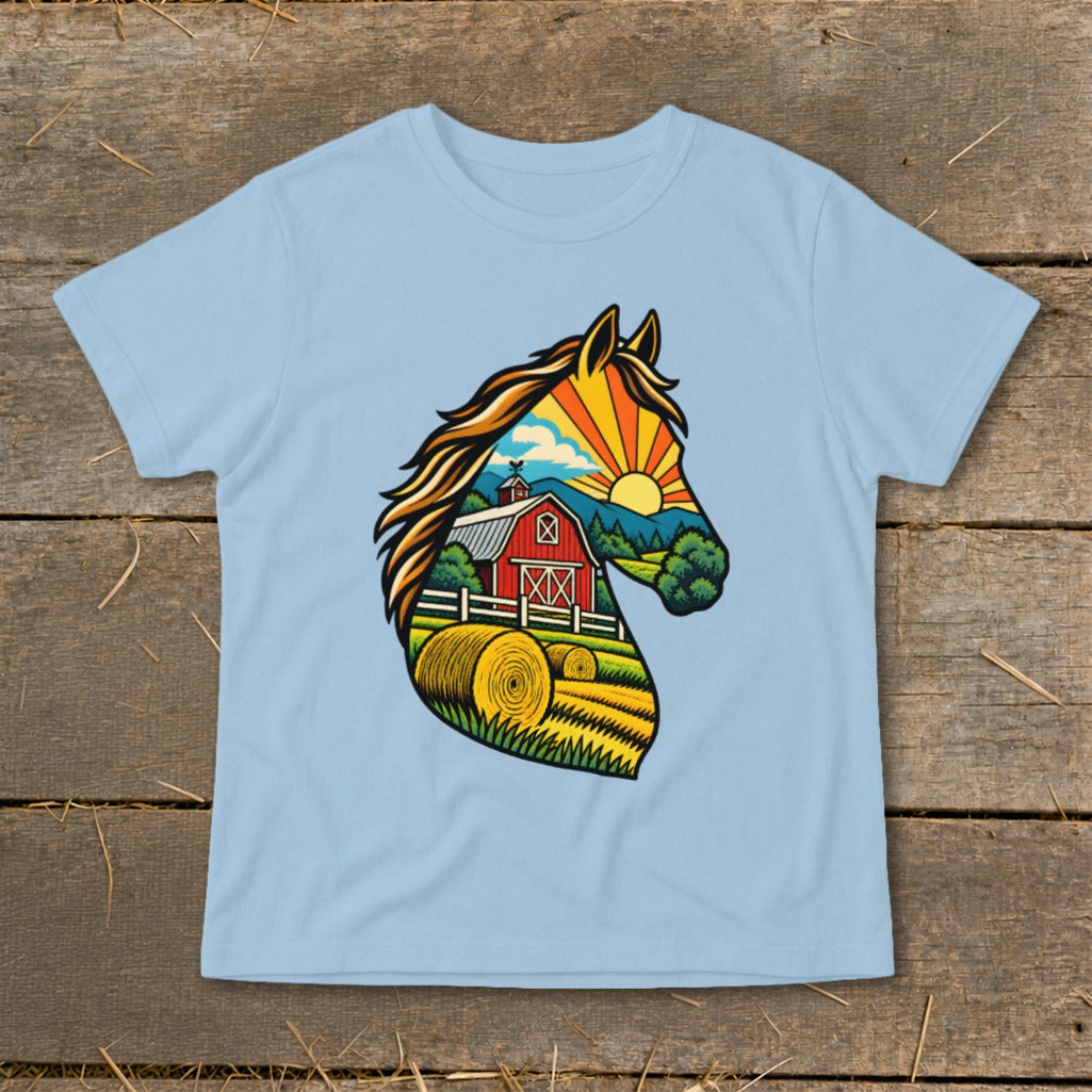 A light blue t-shirt printed with a vibrant horse head graphic containing a farm landscape.