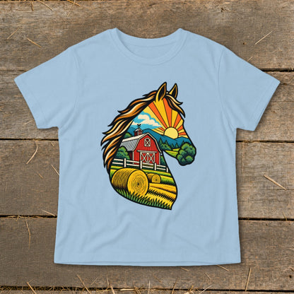 A light blue t-shirt printed with a vibrant horse head graphic containing a farm landscape.