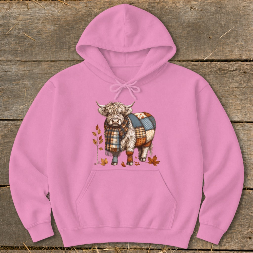 Pink hoodie with a Highland cow wearing a plaid scarf and blanket.