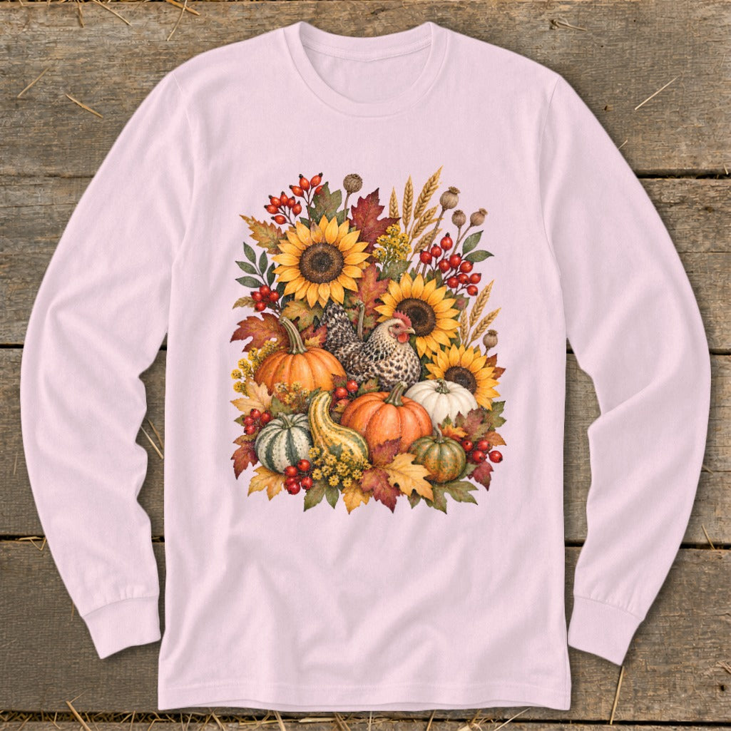 Pink long-sleeve shirt with a watercolor fall harvest design featuring pumpkins, sunflowers, and a chicken.
