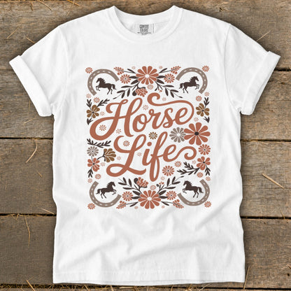White t-shirt with "Horse Life" text, horses, horseshoes, and floral design.