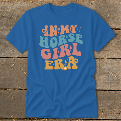 Blue t-shirt with "IN MY HORSE GIRL ERA" text in retro colorful font.