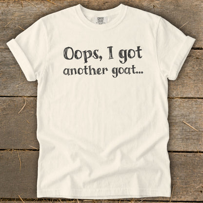 Cream t-shirt with "Oops, I got another goat..." text in black.