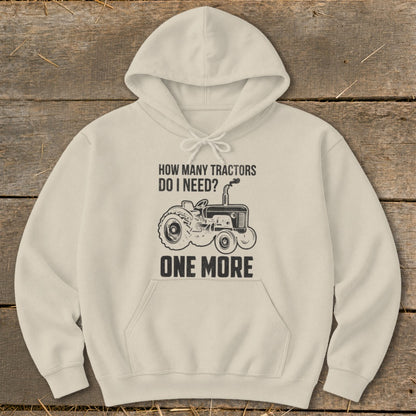 Cream hoodie with tractor graphic and text "HOW MANY TRACTORS DO I NEED? ONE MORE".