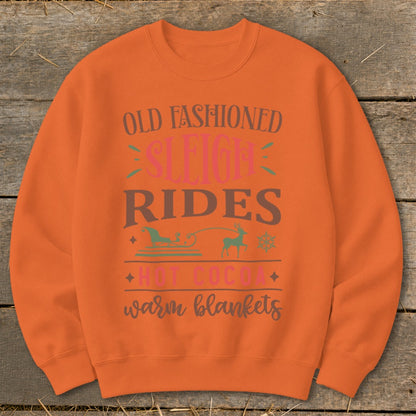 Orange crewneck sweatshirt with "Old Fashioned Sleigh Rides Hot Cocoa Warm Blankets" text.