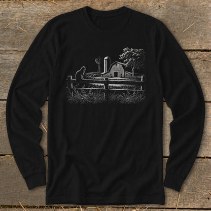 Black long sleeve shirt with a white sketch of a barn, windmill, cat, and fence.