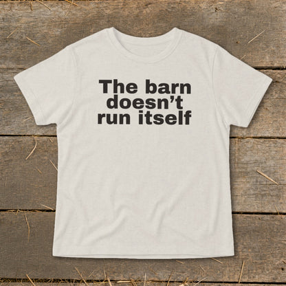 Light cream t-shirt with black text reading "The barn doesn't run itself."