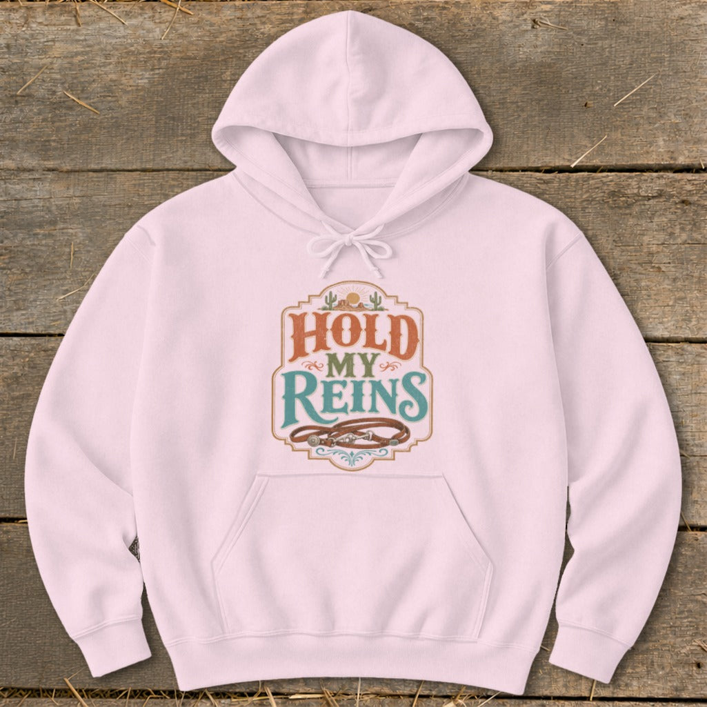 Pink hoodie with "Hold My Reins" text and leather reins graphic.