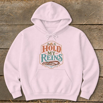 Pink hoodie with "Hold My Reins" text and leather reins graphic.