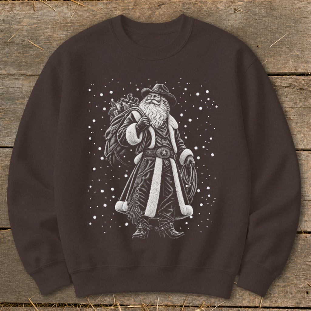 Cowboy Santa with a sack of gifts and a lasso, surrounded by snow.