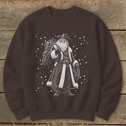 Cowboy Santa with a sack of gifts and a lasso, surrounded by snow.