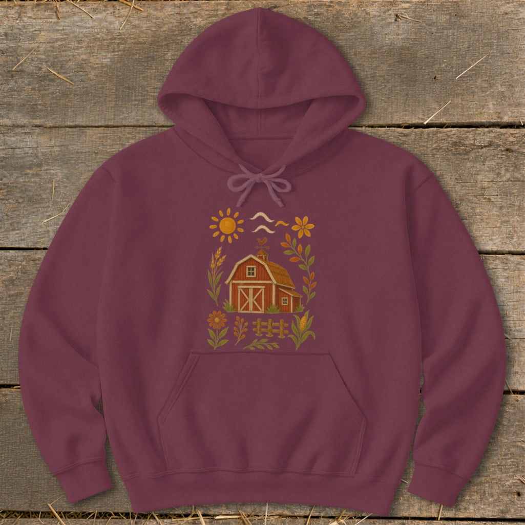 Maroon hoodie with a barn and nature graphic on the chest.
