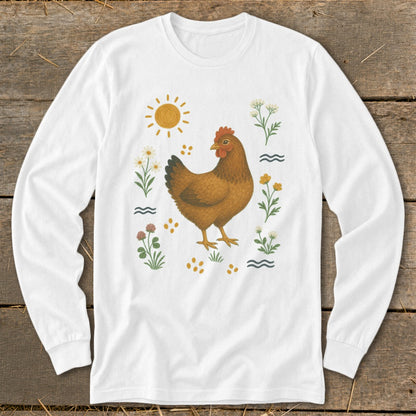 White long-sleeve shirt with a brown chicken surrounded by flowers, sun, and wavy lines.