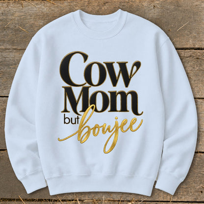 White sweatshirt with "Cow Mom but Boujee" text in black and gold lettering.