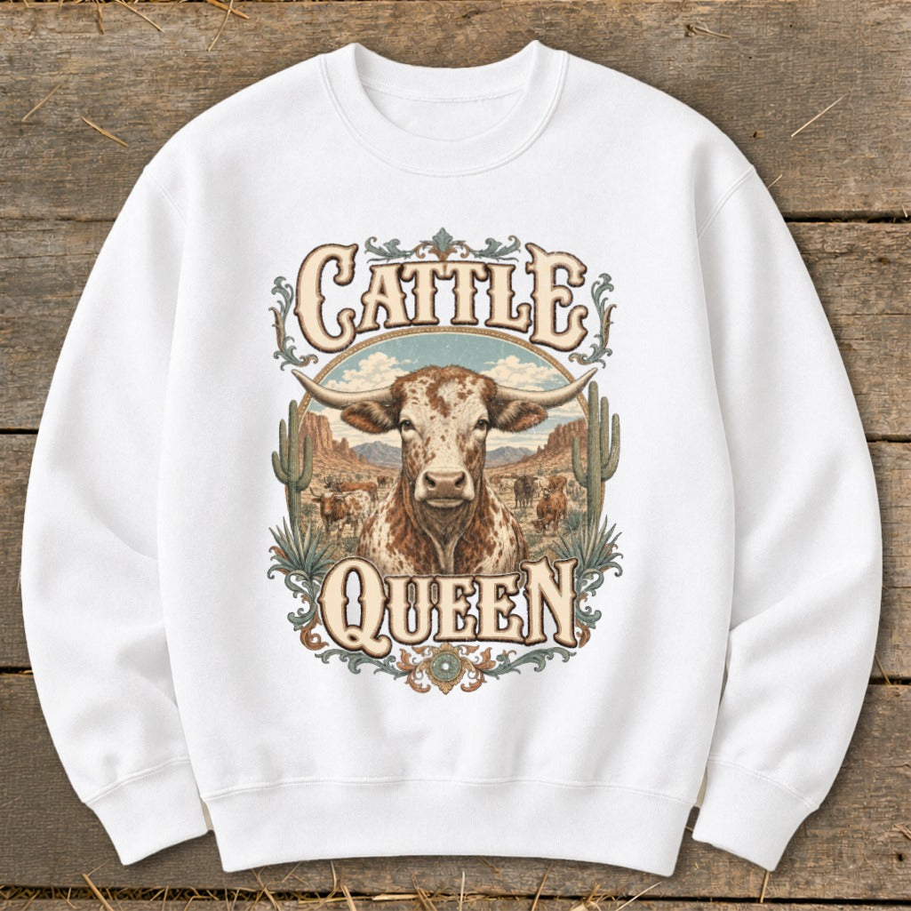 White sweatshirt with "Cattle Queen" text and a longhorn steer in a desert landscape.