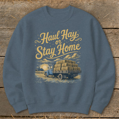 Blue sweatshirt with "Haul Hay or Stay Home" text and a truck loaded with hay bales.
