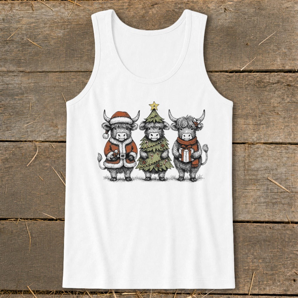 Three Highland cows dressed for Christmas: one in a Santa suit, one as a tree, one with a gift.