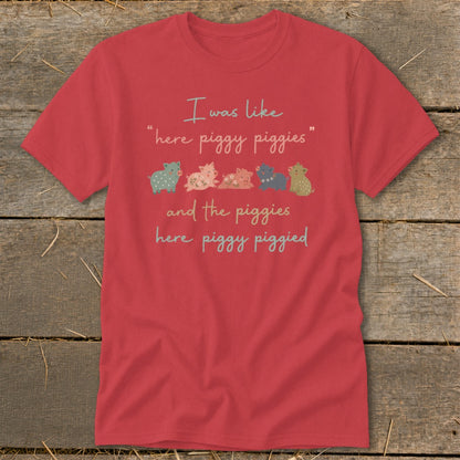 Red t-shirt with "I was like 'here piggy piggies' and the piggies here piggy piggied" and five cartoon pigs.