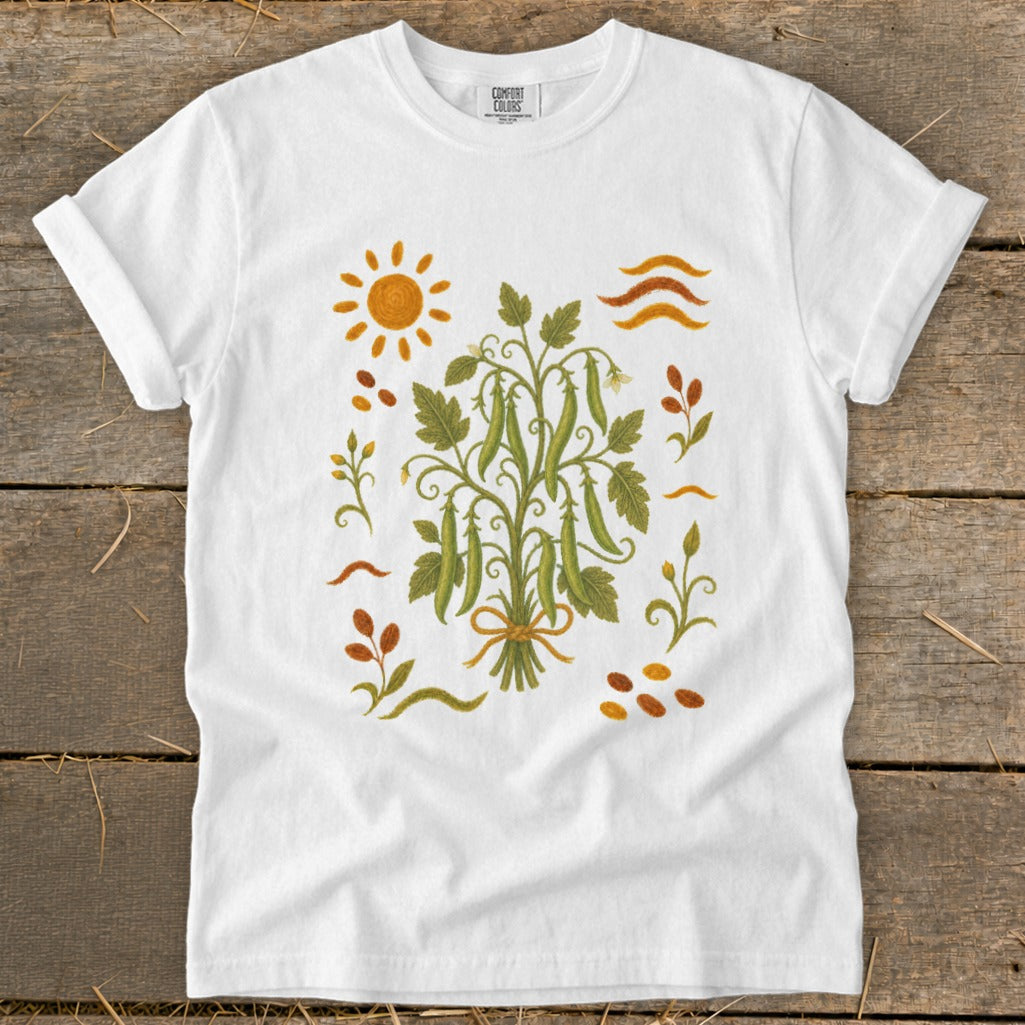 White t-shirt with a botanical illustration of pea pods and sun.