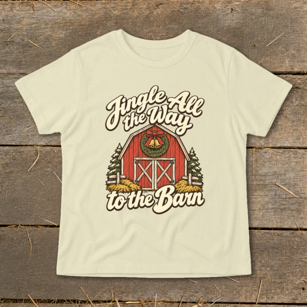 Cream t-shirt with graphic of red barn, Christmas wreath, and text "Jingle All the Way to the Barn".
