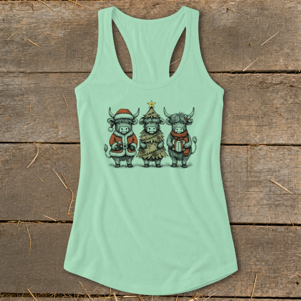 Three Highland cows dressed for Christmas on a mint green tank top.