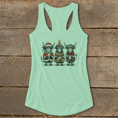 Three Highland cows dressed for Christmas on a mint green tank top.