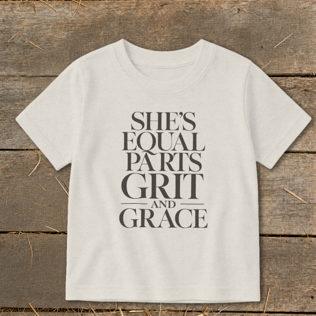 T-shirt with text "SHE'S EQUAL PARTS GRIT AND GRACE".