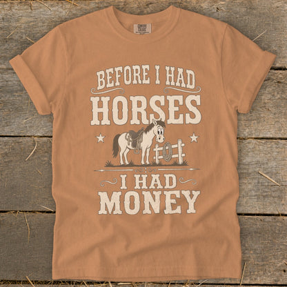 Orange t-shirt with text: BEFORE I HAD HORSES I HAD MONEY and a cartoon horse.