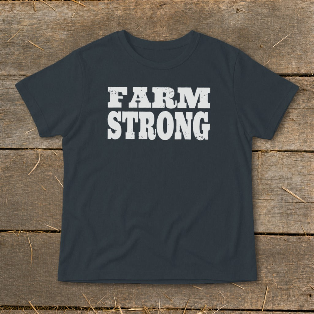 Dark gray short-sleeve t-shirt with white distressed text reading FARM STRONG on a wooden surface.
