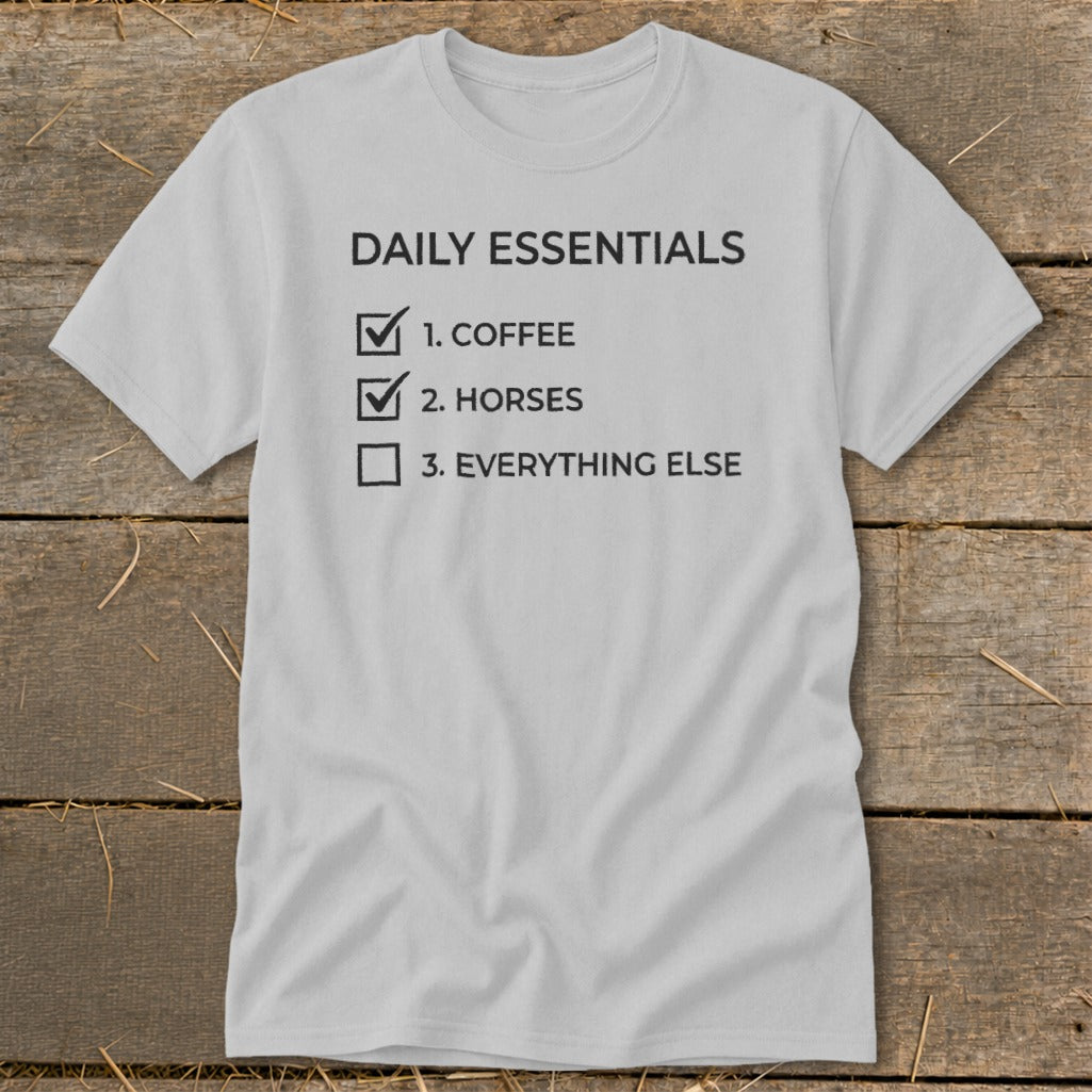 Gray t-shirt with "Daily Essentials" checklist: 1. Coffee, 2. Horses, 3. Everything else.