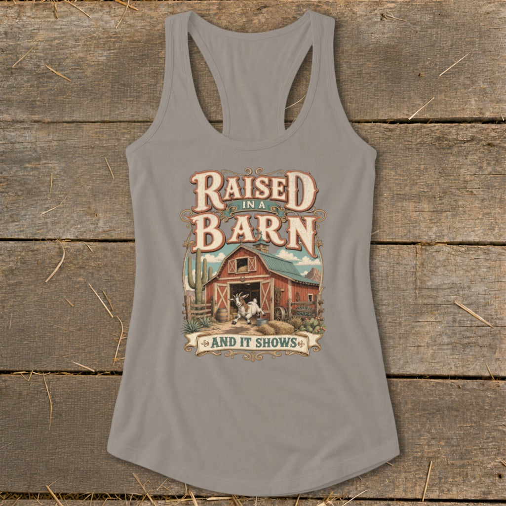 Grey tank top with "Raised in a Barn and It Shows" graphic featuring a goat and barn.