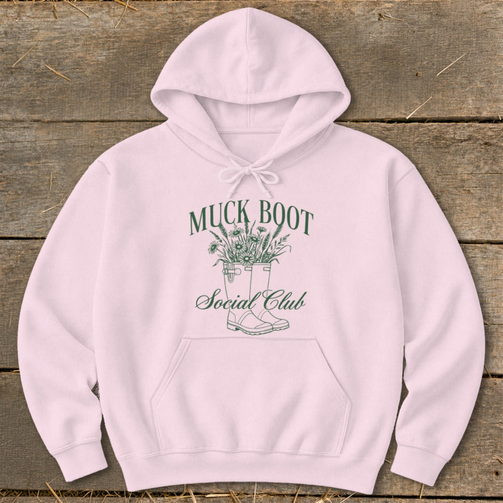 Pink hoodie with a "Muck Boot Social Club" graphic featuring boots and flowers.