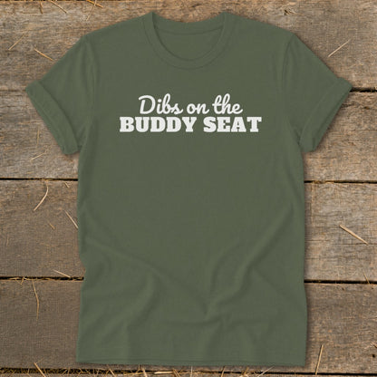 Olive green t-shirt with white text reading "Dibs on the BUDDY SEAT".