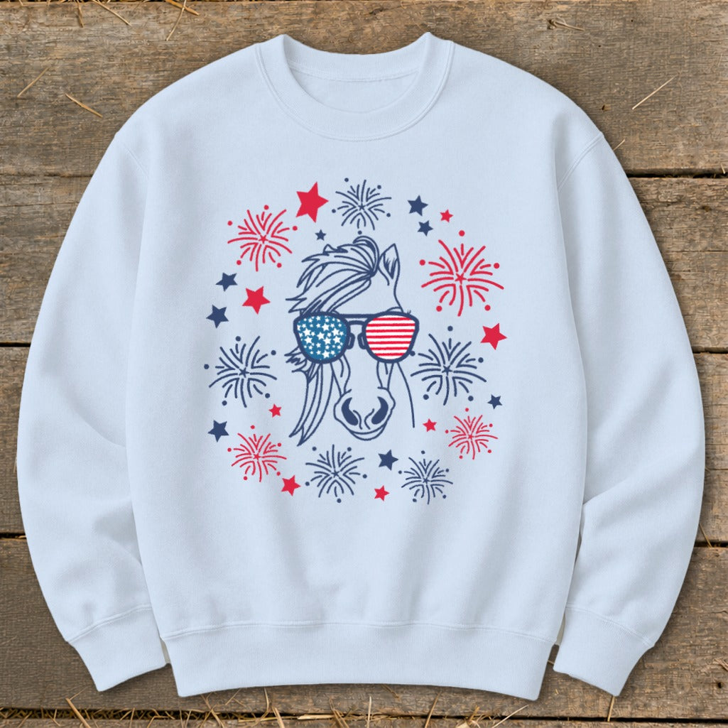 White sweatshirt with a horse wearing patriotic sunglasses surrounded by fireworks.