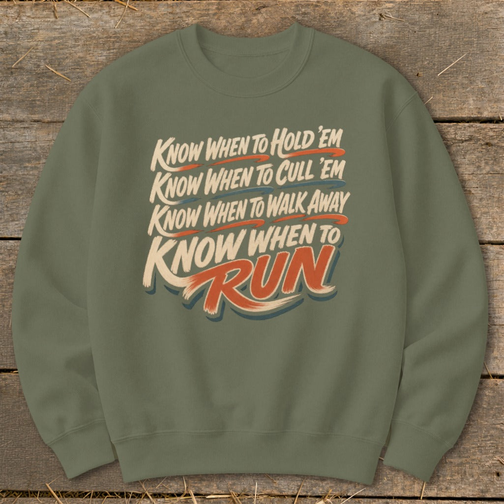 Green crewneck sweatshirt with text: "Know when to hold 'em, know when to cull 'em, know when to walk away, know when to Run".
