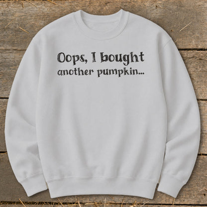 White crewneck sweatshirt with "Oops, I bought another pumpkin..." text.