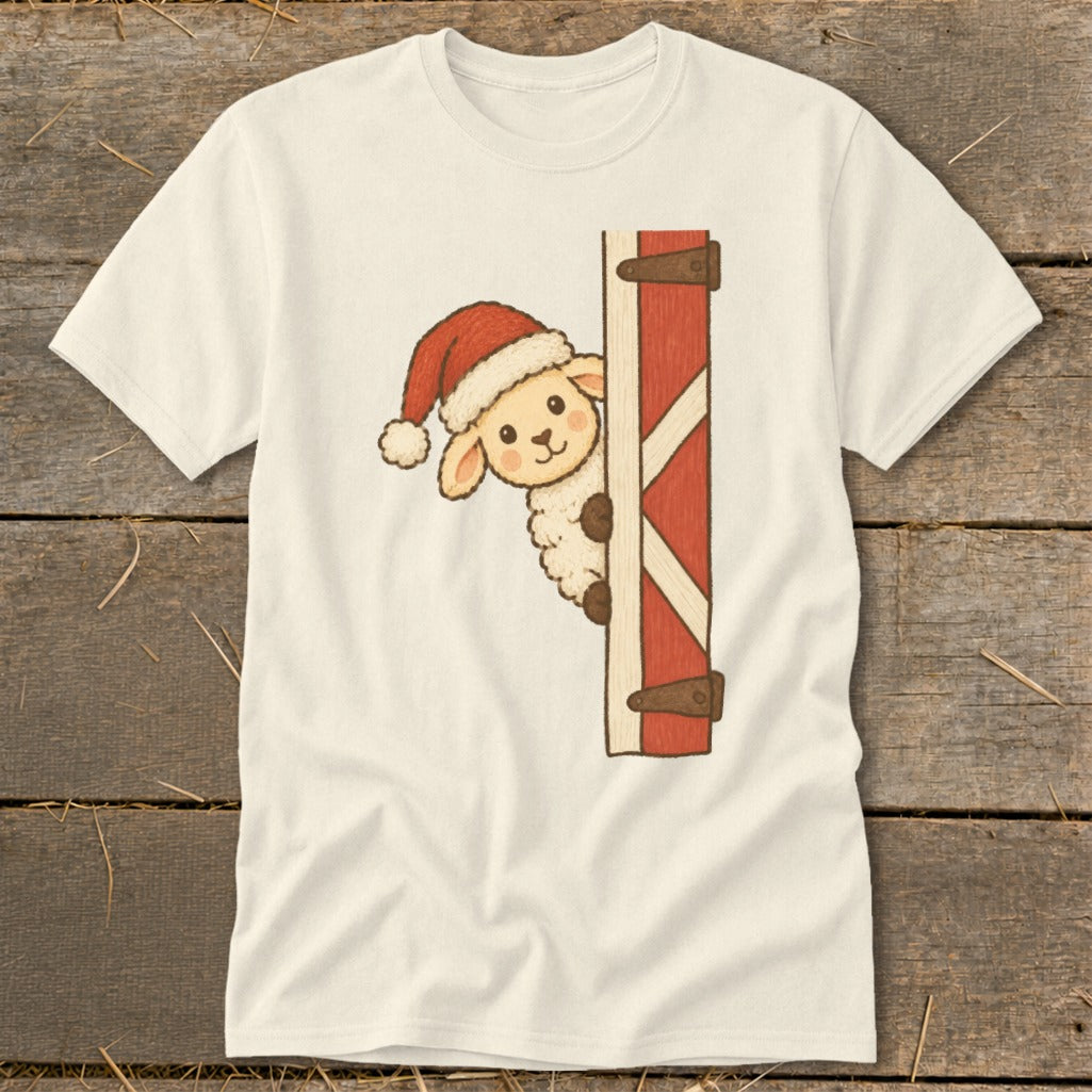 Cream t-shirt with a cartoon sheep wearing a Santa hat peeking around a red barn door.