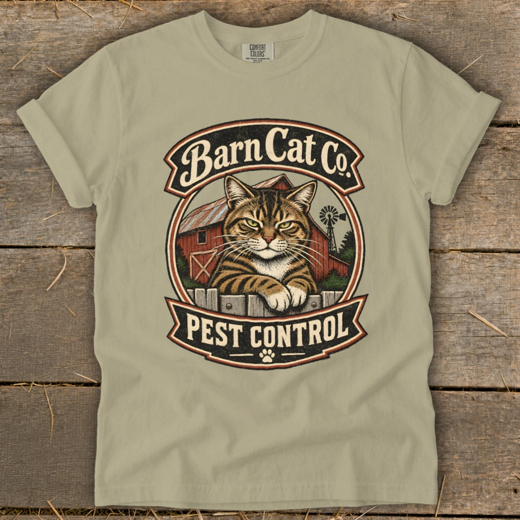 A sage green t-shirt displays a vintage-style graphic of a tabby cat and a barn.