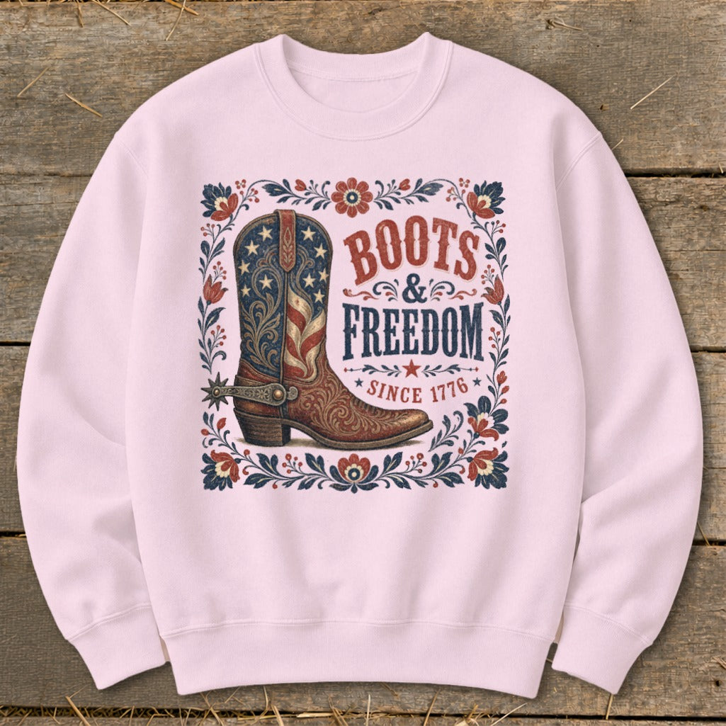 Pink sweatshirt with American flag cowboy boot design and text "Boots & Freedom Since 1776".