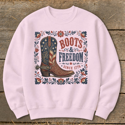 Pink sweatshirt with American flag cowboy boot design and text "Boots & Freedom Since 1776".
