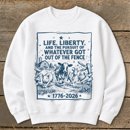 White sweatshirt with "LIFE, LIBERTY, AND THE PURSUIT OF WHATEVER GOT OUT OF THE FENCE 1776-2026" text and farm animals.