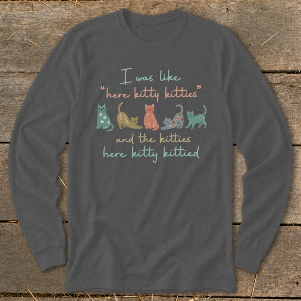 Long sleeve shirt with line of illustrated cats and "here kitty kitties" text.
