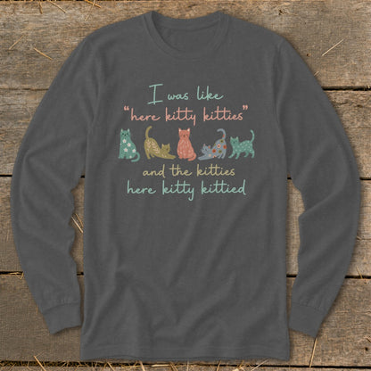 Long sleeve shirt with line of illustrated cats and "here kitty kitties" text.