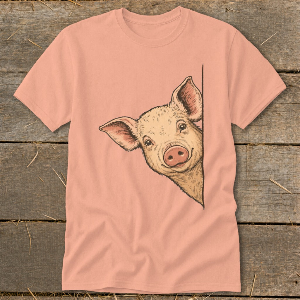 Pink t-shirt with a drawing of a pig peeking from the side.