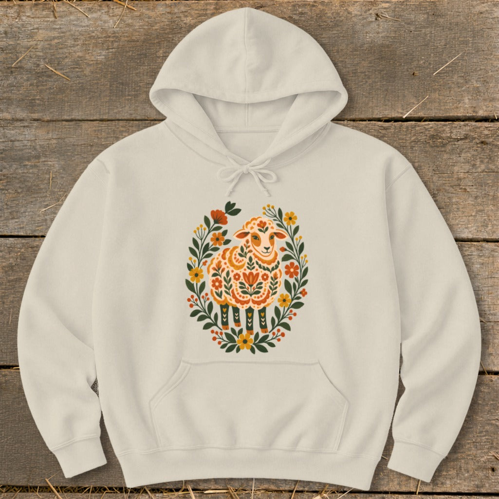 Cream hoodie with a colorful folk art sheep surrounded by flowers.