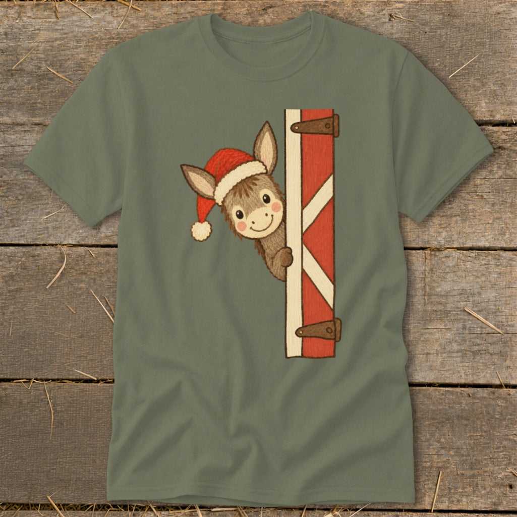 Donkey wearing a Santa hat peeking from behind a barn door.